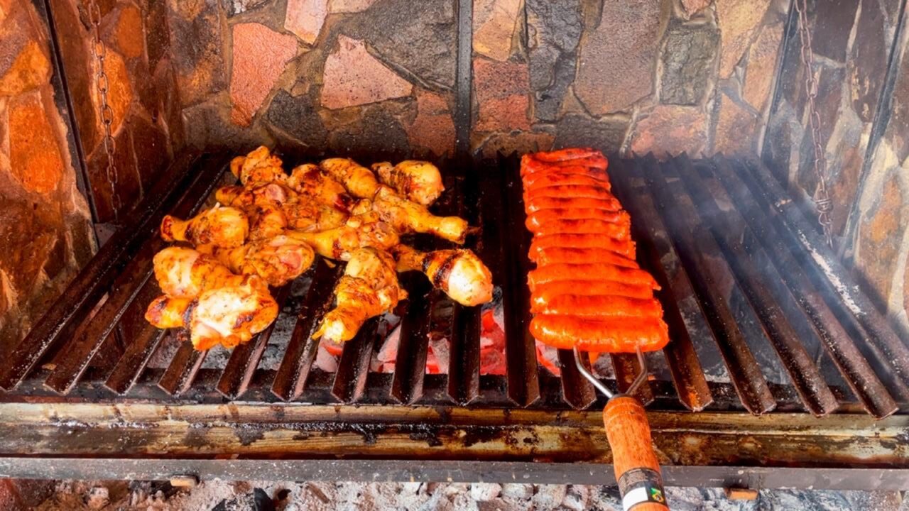 Carnes y chorizos cocinándose sobre la parrilla